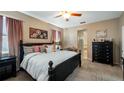 Spacious main bedroom with ensuite bathroom and decorative wall art at 412 Arbor Pointe Ave, Minneola, FL 34715