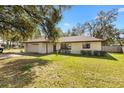 Well-maintained single-story home with an attached garage and green lawn at 4723 Cr 306, Lake Panasoffkee, FL 33538