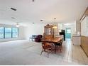 Spacious living room with tile flooring, large windows, and an adjoining dining area with wood accents at 4918 County Road 114, Wildwood, FL 34785