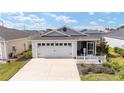 Well-maintained single-story home with a long driveway and attached two-car garage at 5432 Todd Ct, The Villages, FL 32163