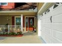 Close up of the front entrance, showcasing the door, porch, and landscaping at 600 Urick St, Fruitland Park, FL 34731