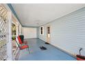 Spacious carport with painted floor, convenient garage access, and ample space for parking at 705 Cortez Ave, The Villages, FL 32159