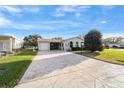 Inviting single-story home boasting a large driveway and attached garage at 736 Heathrow Ave, The Villages, FL 32159