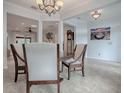 Spacious dining area with decorative lighting, neutral colors, and views into adjacent rooms at 9052 Se 130Th Loop, Summerfield, FL 34491