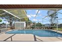 Relaxing screened-in pool with a large deck, perfect for summer fun at 909 Palm Forest Ln, Minneola, FL 34715