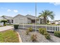Charming home featuring white picket fence, decorative rock garden and well-manicured landscaping at 9312 Se 172Nd Wayside Pl, The Villages, FL 32162