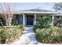 Inviting front entrance with a walkway lined with manicured hedges at 10648 Lake Hill Dr, Clermont, FL 34711