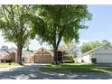 Attractive home features mature trees, a two-car garage, and a cozy front porch at 10910 Rushwood Way, Clermont, FL 34714