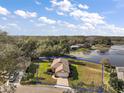 An aerial view of the property showcasing the home's location and large, well-maintained yard with lake access at 125 Twin Lake Cir, Umatilla, FL 32784