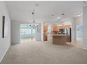 Open-concept living space featuring a view to kitchen, neutral carpet and colors providing a seamless flow at 1414 Georgetown Ave, The Villages, FL 32162