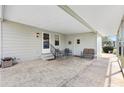 Spacious carport area with outdoor seating, lighting, and access to the home at 1523 W Schwartz Blvd, The Villages, FL 32159