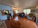 Spacious living room featuring bright windows, ceiling fan, and access to dining area at 1532 W Schwartz Blvd, Lady Lake, FL 32159