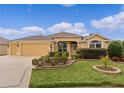 Well-maintained single-story home with a two-car garage and manicured lawn at 1938 Sassparilla Way, The Villages, FL 32162