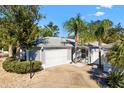 Charming home featuring a two-car garage, well-manicured landscaping, and a welcoming entrance at 1952 Peachtree Ave, The Villages, FL 32162