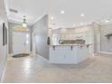 Bright and airy entryway leading into the kitchen with tile floors at 2197 Derringer Ave, The Villages, FL 32162