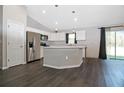 Modern kitchen with stainless steel appliances, white cabinets, and island at 22325 Sw Nectarine Ln, Dunnellon, FL 34431