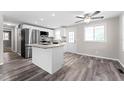 Bright kitchen features stainless steel appliances, white cabinets, and a central island at 2714 Vindale Rd, Tavares, FL 32778
