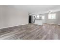 Spacious living room showcases new flooring and leads to an open kitchen area at 2714 Vindale Rd, Tavares, FL 32778