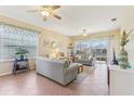 Spacious living room with tile flooring, ceiling fans and lots of natural light at 27536 Stoney Brook Dr, Leesburg, FL 34748