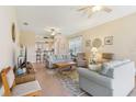 Open living room with tile floors and view to the breakfast bar and kitchen at 27536 Stoney Brook Dr, Leesburg, FL 34748