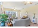 Bright living room with tile flooring, ceiling fans, and comfortable seating at 27536 Stoney Brook Dr, Leesburg, FL 34748