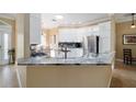 Bright kitchen boasts sleek countertops, stainless steel appliances, and ample cabinet space at 3234 Berkeley Ln, The Villages, FL 32162