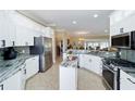 Spacious kitchen features modern appliances and marble countertops at 3234 Berkeley Ln, The Villages, FL 32162