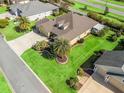 Expansive property with mature landscaping, sunroom, and well-maintained lawn at 3654 Enterprise Dr, The Villages, FL 32163