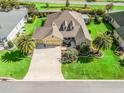 Desirable neighborhood with manicured lawns, a three-car garage, and mature palms at 3654 Enterprise Dr, The Villages, FL 32163