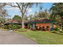 Charming home featuring vibrant landscaping and a spacious front yard that invites you to relax and enjoy outdoor living at 36816 Taylor Mill Rd, Fruitland Park, FL 34731