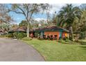 Lush front yard showcasing a well-kept lawn and a beautiful home with mature trees and attractive landscaping at 36816 Taylor Mill Rd, Fruitland Park, FL 34731