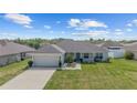 Single-story home with a well-maintained lawn and a two-car attached garage at 4000 Se 98Th Pl, Belleview, FL 34420