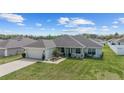 Single-story home with a well-maintained lawn and a two-car attached garage at 4000 Se 98Th Pl, Belleview, FL 34420
