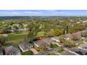 Aerial view of a community showcasing the house and the surrounding green landscape at 4110 Hammersmith Dr, Clermont, FL 34711