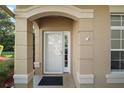 Charming front porch with stone pillars highlighting the entrance and secured by a camera at 5466 Compass Pt # 101, Oxford, FL 34484