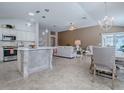 Open-concept living area connects the kitchen, dining, and sitting areas, promoting an inclusive and airy atmosphere at 591 Statesburg St, The Villages, FL 32162