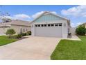 Attractive home with a two-car garage, well-manicured lawn, and inviting driveway at 5934 Kaplan Ct, The Villages, FL 32163