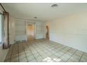 Inviting living room featuring tile floors, built-in shelving, and easy access to other rooms at 618 N Grandview St, Mount Dora, FL 32757