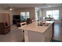 Open concept kitchen with an island overlooking the living and dining areas; great for entertaining at 7133 Sw 135Th Pl, Ocala, FL 34473