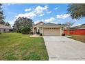 Well-manicured front lawn leads to this single Gathering home with attached garage at 81 Golfview Cir, Umatilla, FL 32784