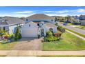 Inviting two-story home with a landscaped yard, brick driveway, and a convenient two-car garage at 831 Zeek Ridge Ct, Clermont, FL 34715