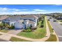Beautiful two-story home boasts well-manicured landscaping, a brick driveway, and an attached two-car garage at 831 Zeek Ridge Ct, Clermont, FL 34715