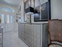Entryway featuring modern cabinet storage, decor, and chair with view to front door at 998 Sayle St, The Villages, FL 32162