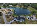 Stunning aerial view of waterfront home with a private pool and multiple docks on a picturesque lake at 12066 Se 60Th Avenue Rd, Belleview, FL 34420