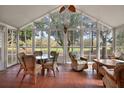 Bright sunroom with tile floors, floor to ceiling windows, and views of the verdant landscape at 1209 Barcelona Dr, The Villages, FL 32159