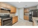 Well-lit kitchen with stainless steel appliances, tile backsplash, and ample counter space at 140 Lake Catherine Cir, Groveland, FL 34736