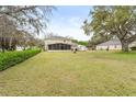 Expansive backyard with screened lanai, storage shed, and ample space for outdoor activities at 16456 Meredrew Ln, Clermont, FL 34711