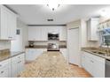 A well-lit kitchen with white cabinets, granite counters, stainless appliances, and central island at 16456 Meredrew Ln, Clermont, FL 34711