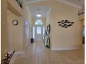 Inviting foyer with tile flooring, high ceilings, and a decorative mirror on the wall at 1670 Kensington Pl, The Villages, FL 32162