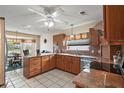 Well-lit kitchen with granite counters, tile floors, and stainless steel appliances at 1732 Madero Dr, The Villages, FL 32159